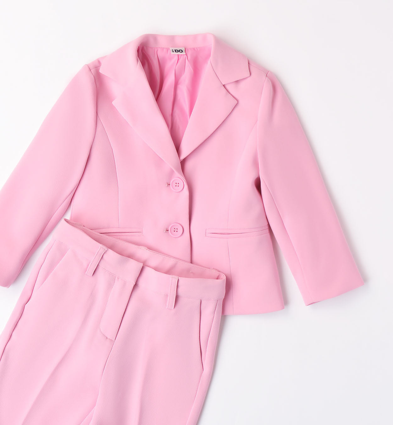 Blazer bambina rosa confetto con bottoni tono su tono e fiori decorativi.