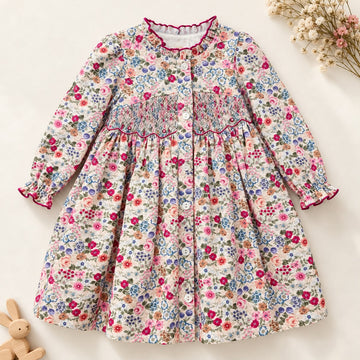 Abito bambina floreale in cotone con punto smock, colletto arricciato e dettagli bordeaux Kidivi.