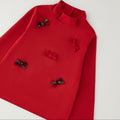 Lupetto bambina rosso in cotone con collo alto e cinque fiocchetti decorativi