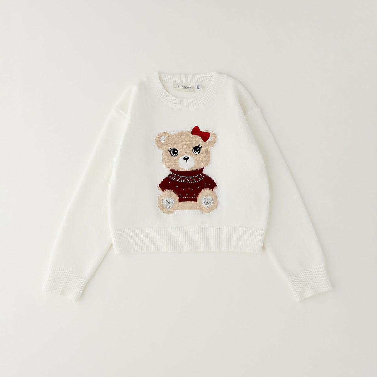 Maglioncino panna Sarabanda per bambina con orsetto, fiocco rosso e dettagli luminosi