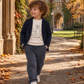Bambino con maglione blu e pantalone panna, look autunnale elegante