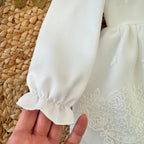 manica lunga con arricciatura elegante