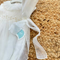 Pagliaccetto battesimo bimba avorio con punto smock, ricami beige e volant