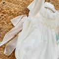 Pagliaccetto battesimo bimba avorio con punto smock, ricami beige e volant