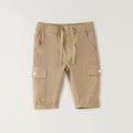 Pantalone cargo bambino beige in cotone elasticizzato visto posteriormente con tasche applicate