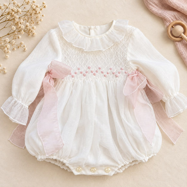 Pagliaccetto battesimo bimba con smock e fiocchi rosa