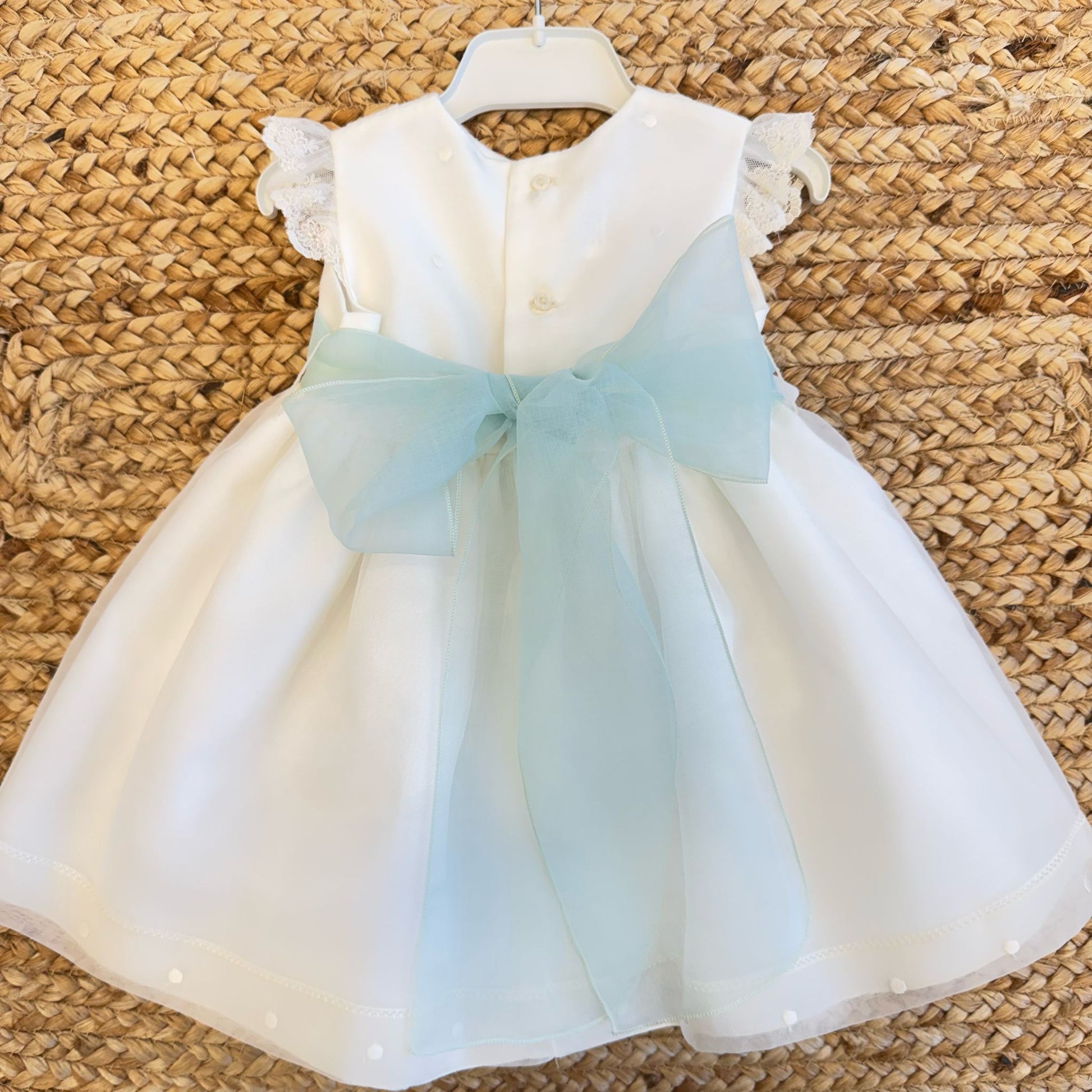 Retro dell’abito battesimo neonata con maxi fiocco verde acqua