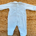 Tutina neonato in ciniglia color cielo con colletto bianco ricamato.