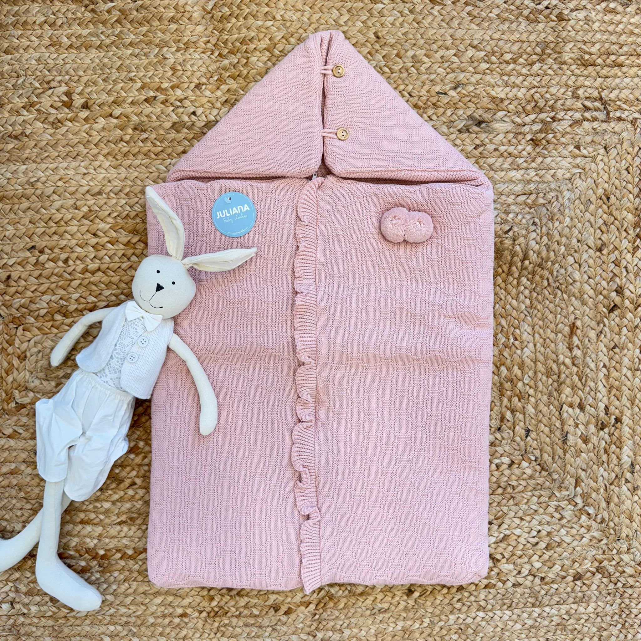 sacco nascita neonata misto lana rosa su tappeto