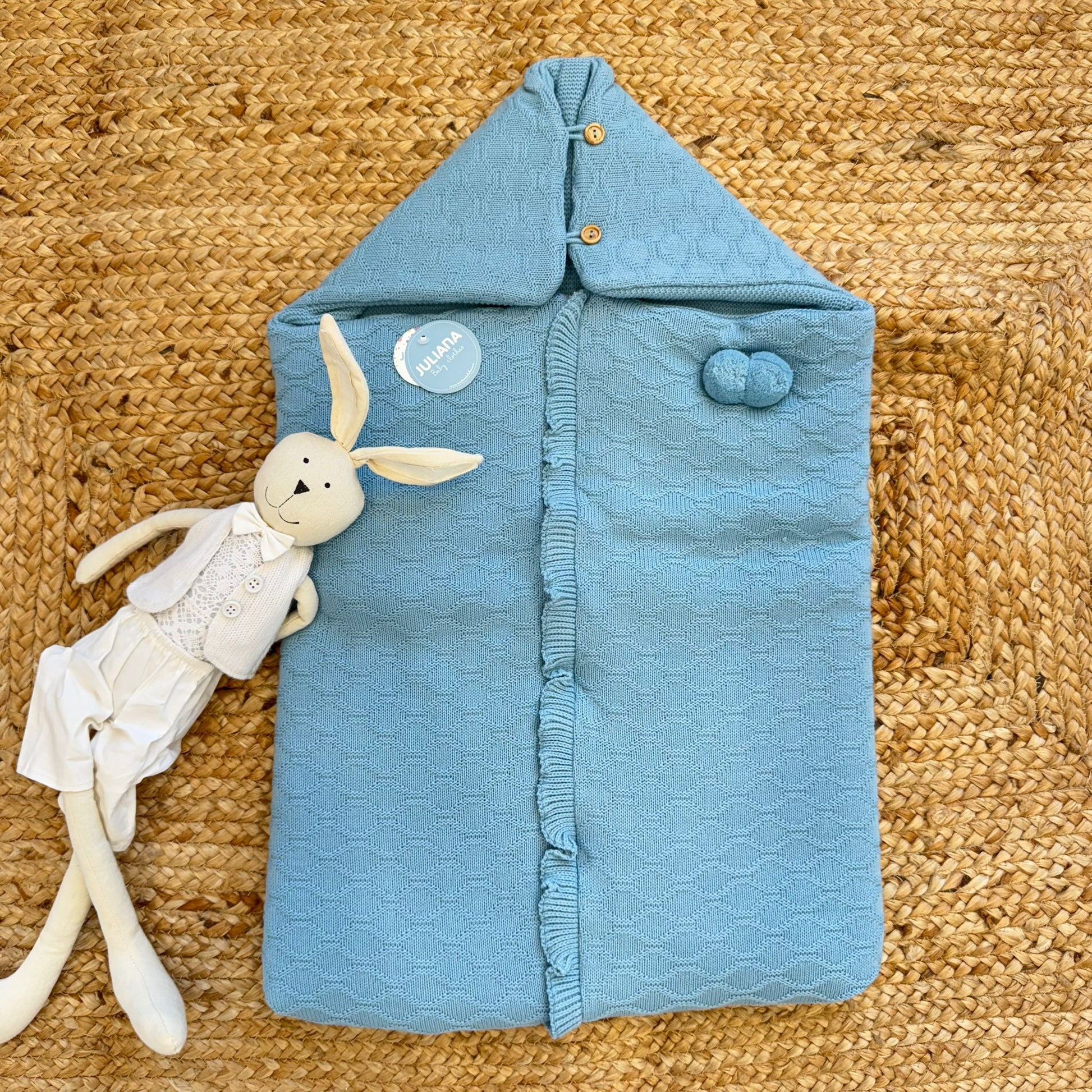 sacco nascita neonato misto lana azzurro su tappeto