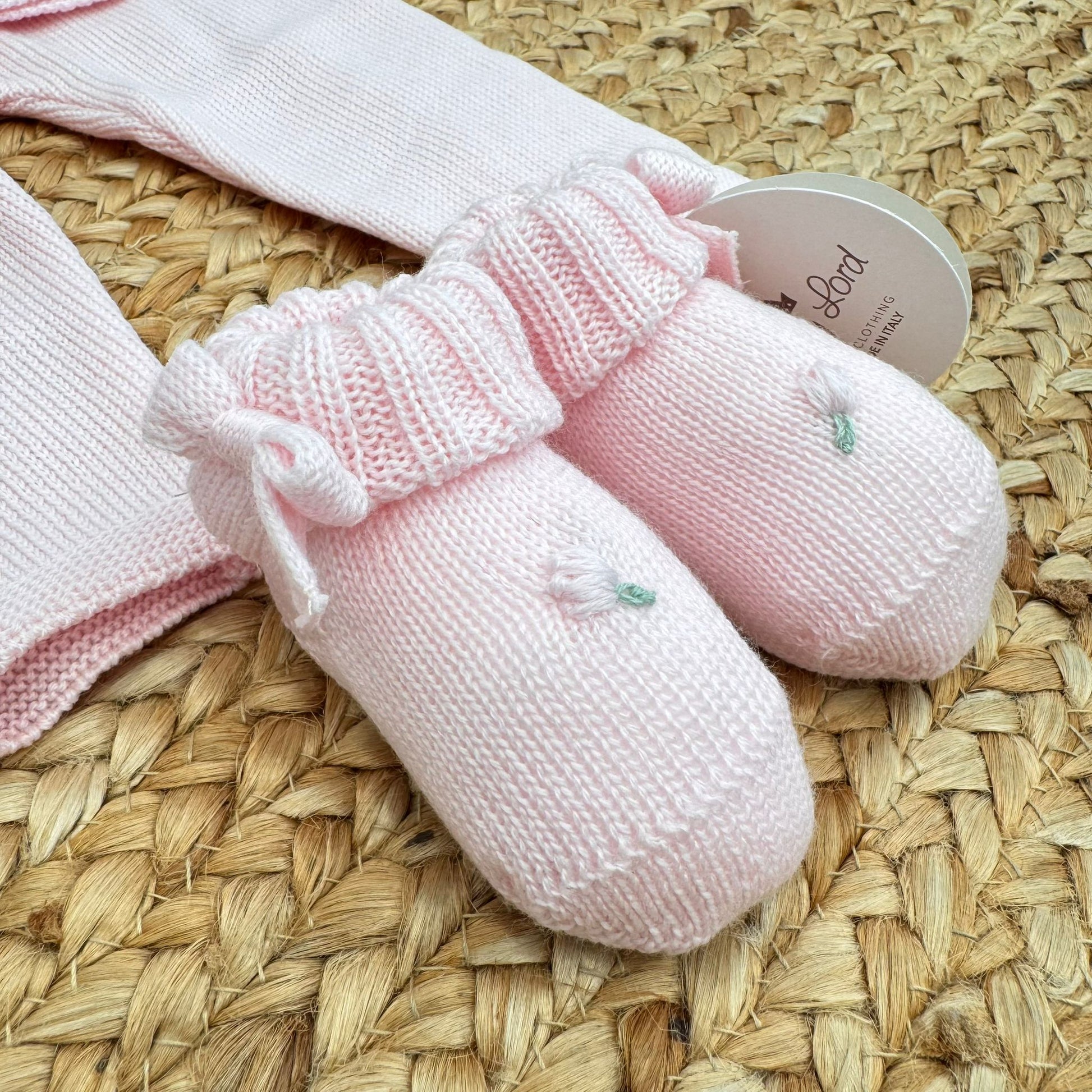 Scarpette rosa con fiocchetti e ricamo floreale in pura lana