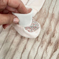 Scarpine in ciniglia rosa con inserto floreale abbinate alla tutina