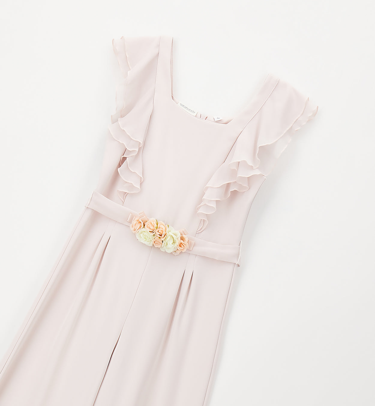 dettaglio tutina bimba elegante con applicazione floreale