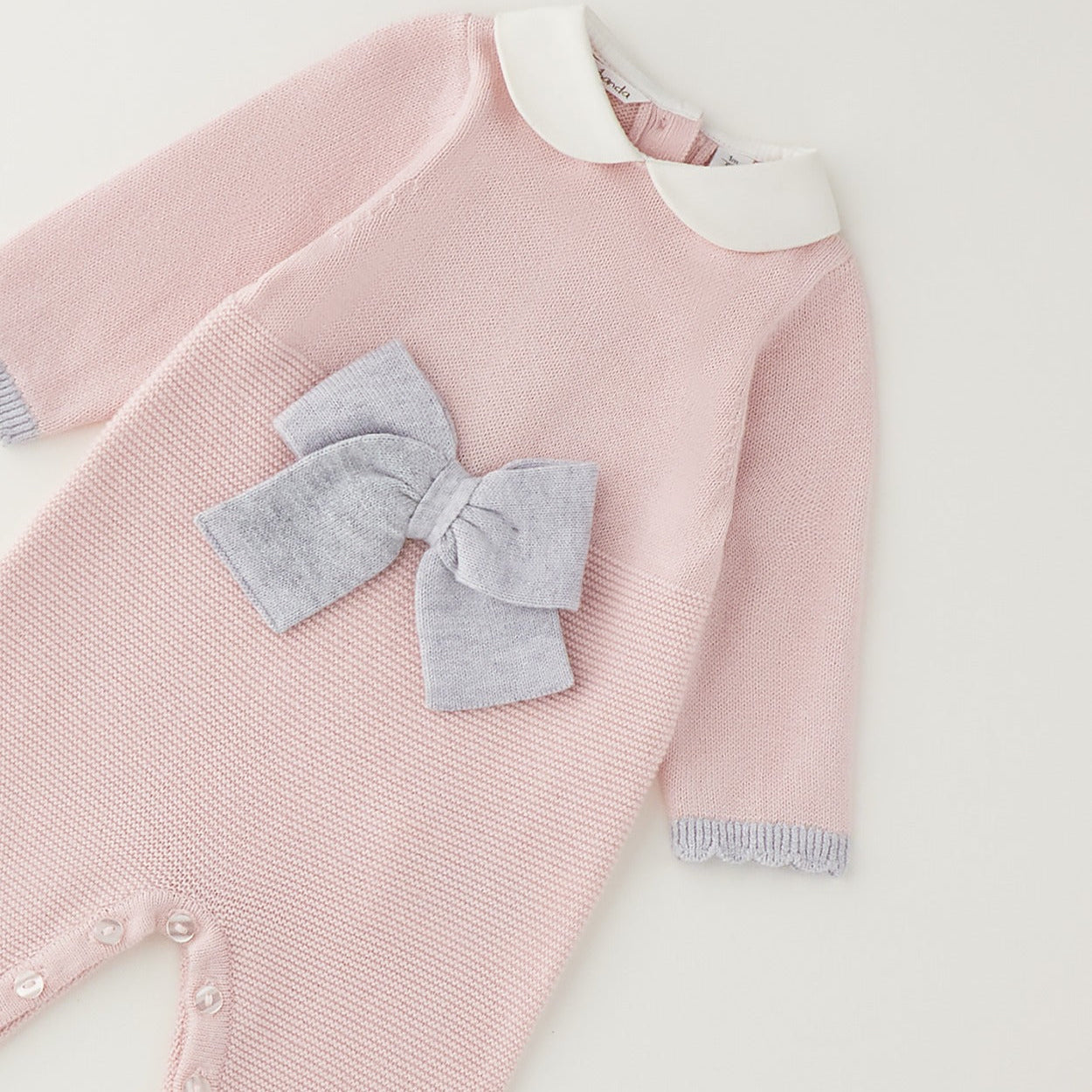 Tutina neonata rosa e grigio con fiocco, colletto bianco e finiture ai polsini per corredino nascita.