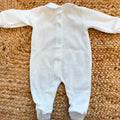 Tutina neonata in ciniglia color latte e beige con fiocchetti ricamati, ideale per corredino nascita