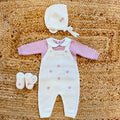 Tutina neonata in pura lana bianca e rosa con salopette e ricami floreali