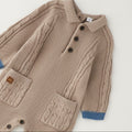 Tutina neonato tricot beige in 80% cotone e 20% lana con trecce, taschine e dettagli petrolio