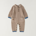 Tutina neonato tricot beige in 80% cotone e 20% lana con trecce, taschine e dettagli petrolio