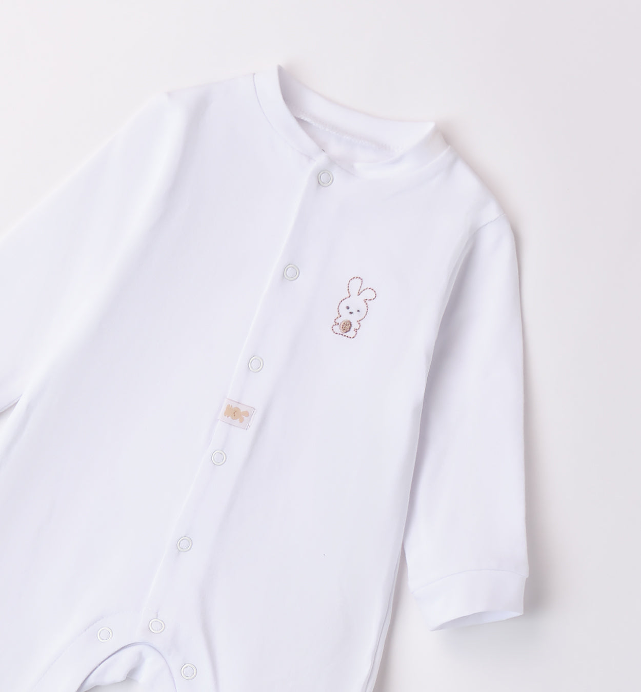  Retro della tutina unisex per neonato con piedini coperti.