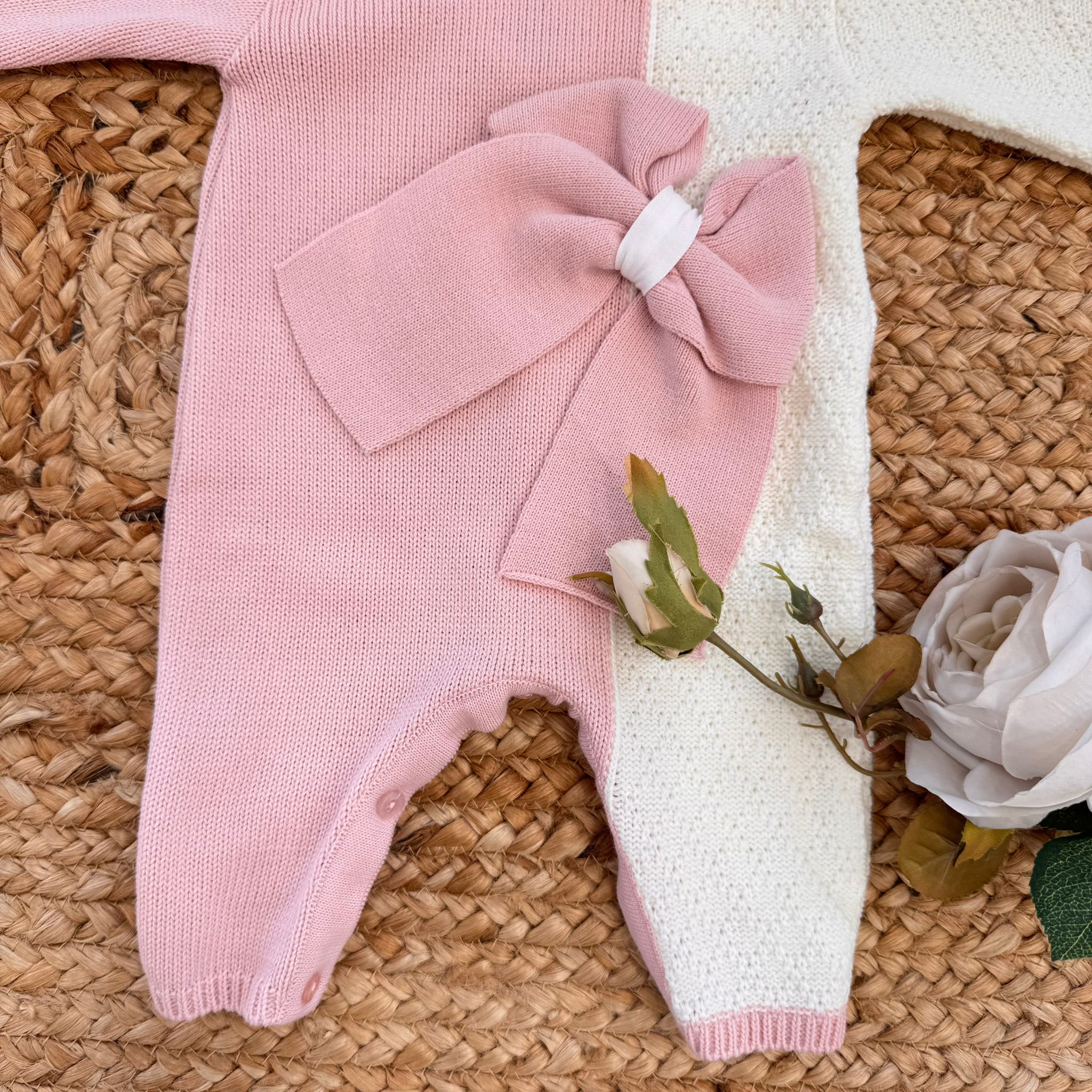 Parte inferiore della tutina con apertura e fiocco decorativo rosa