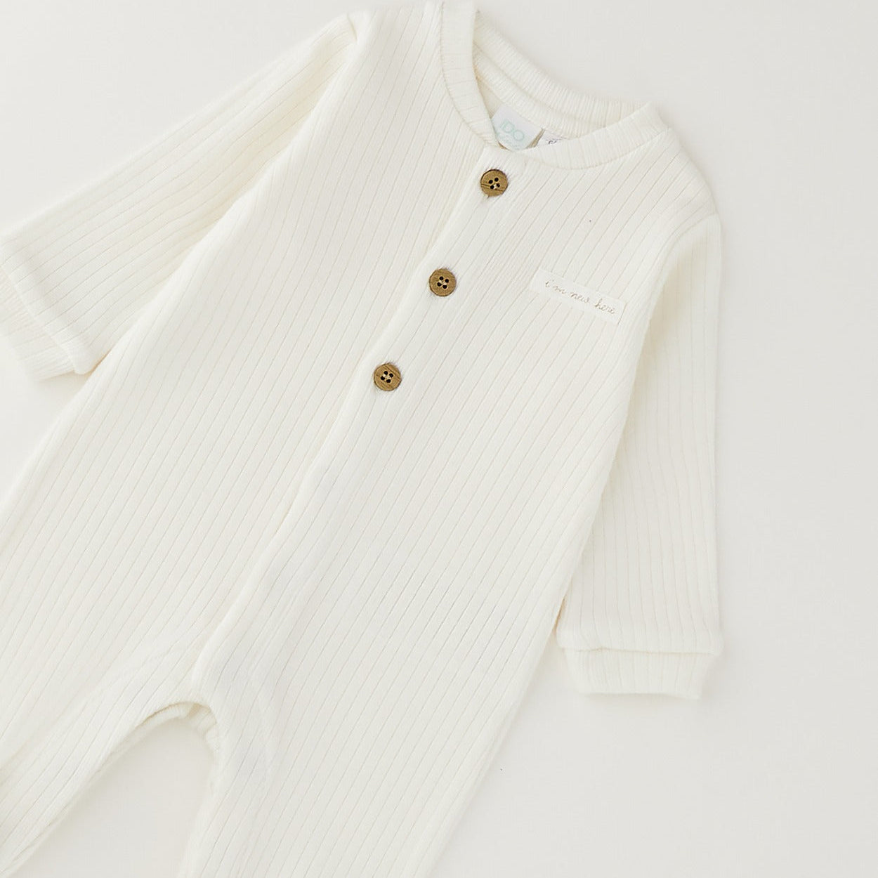 Tutina unisex neonato in caldo cotone bianco latte con bottoncini e piedini chiusi