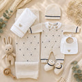 Tutina neonato beige in lana e cotone con dettagli blu e bavetta bianca con orsetto ricamato