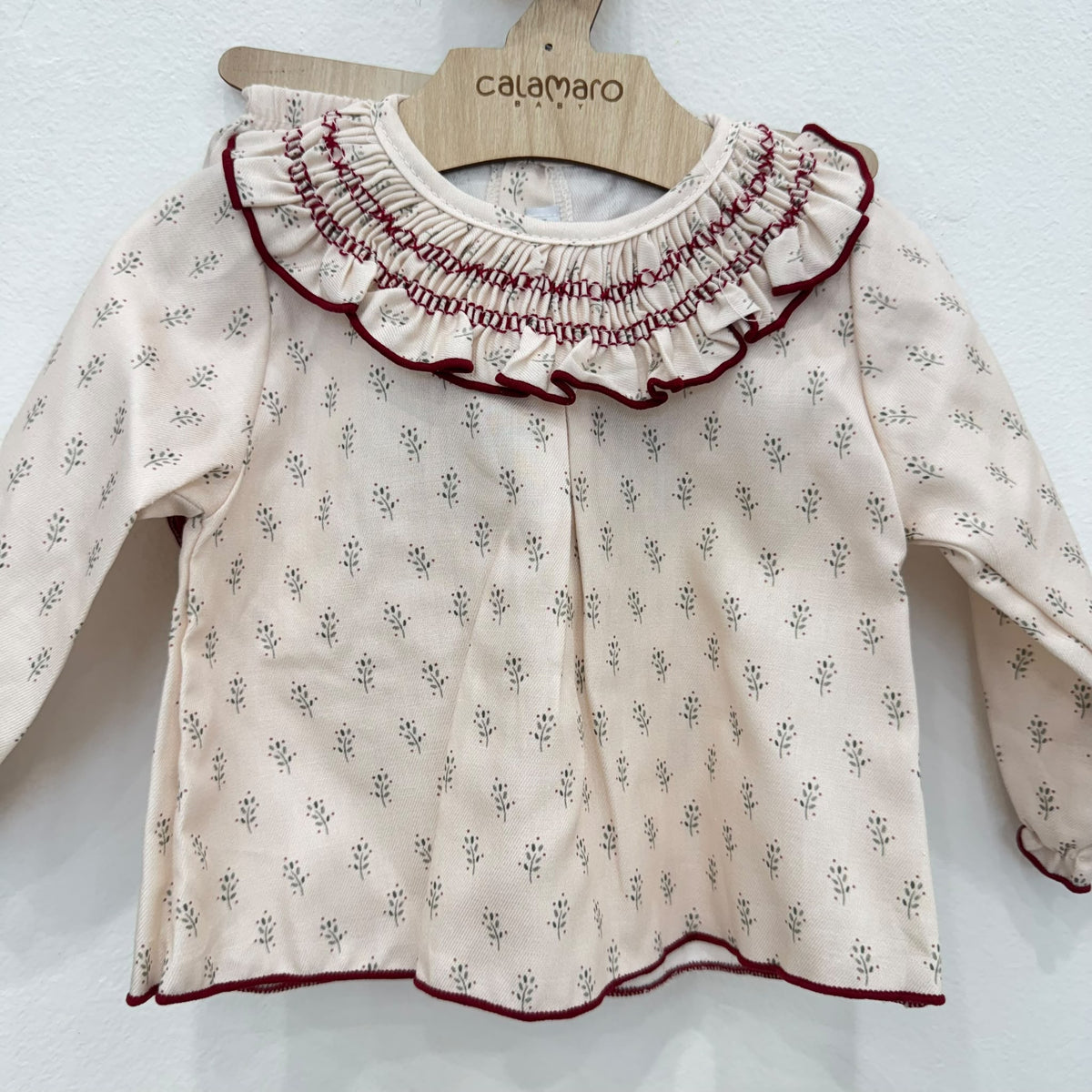 Vestitino neonata panna con fantasia floreale e colletto volant bordeaux
