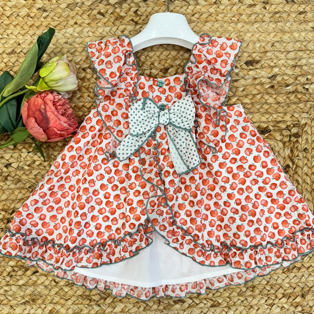  Abito estivo per bambina con fiocco bianco a pois verdi sul retro, volant e chiusura con bottoncini.