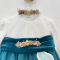 Dettaglio abito elegante bimba in velluto ottanio con corpetto panna e fiori rosa