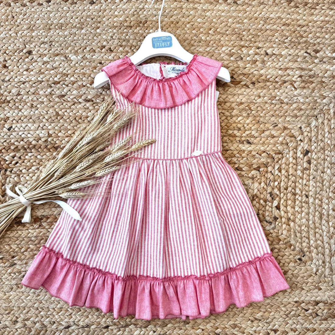 Vestito estivo bambina a righe rosa con volant e grande fiocco dietro