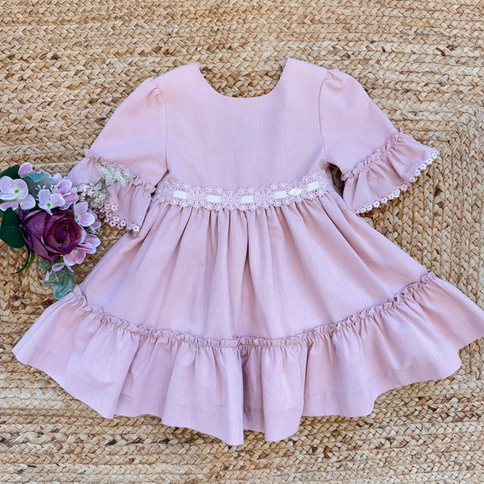 Vestito bambina elegante rosa cipria con pizzo in vita e balze morbide.