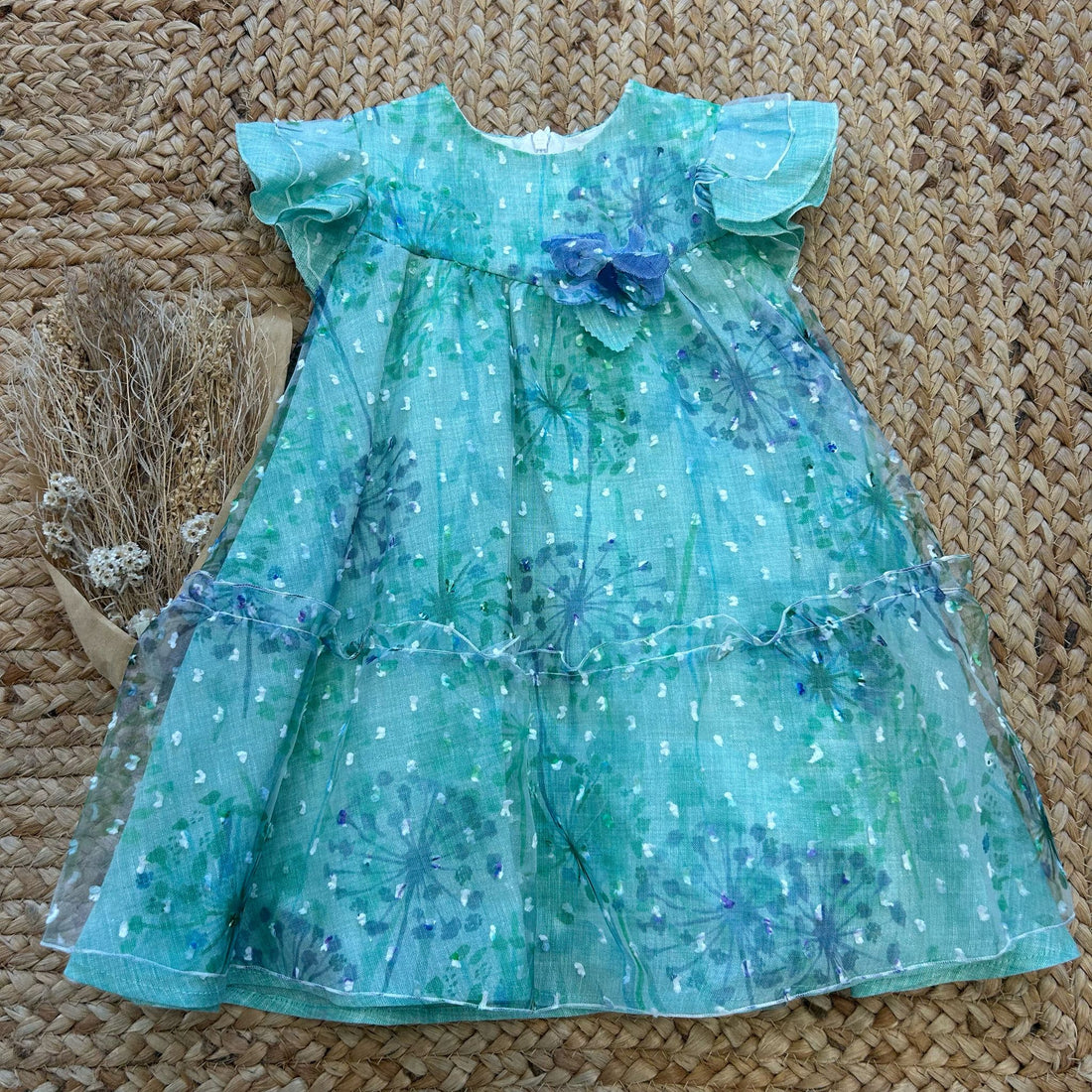 Vestito bambina verde salvia con fiori stampati, volant e fiocco blu


